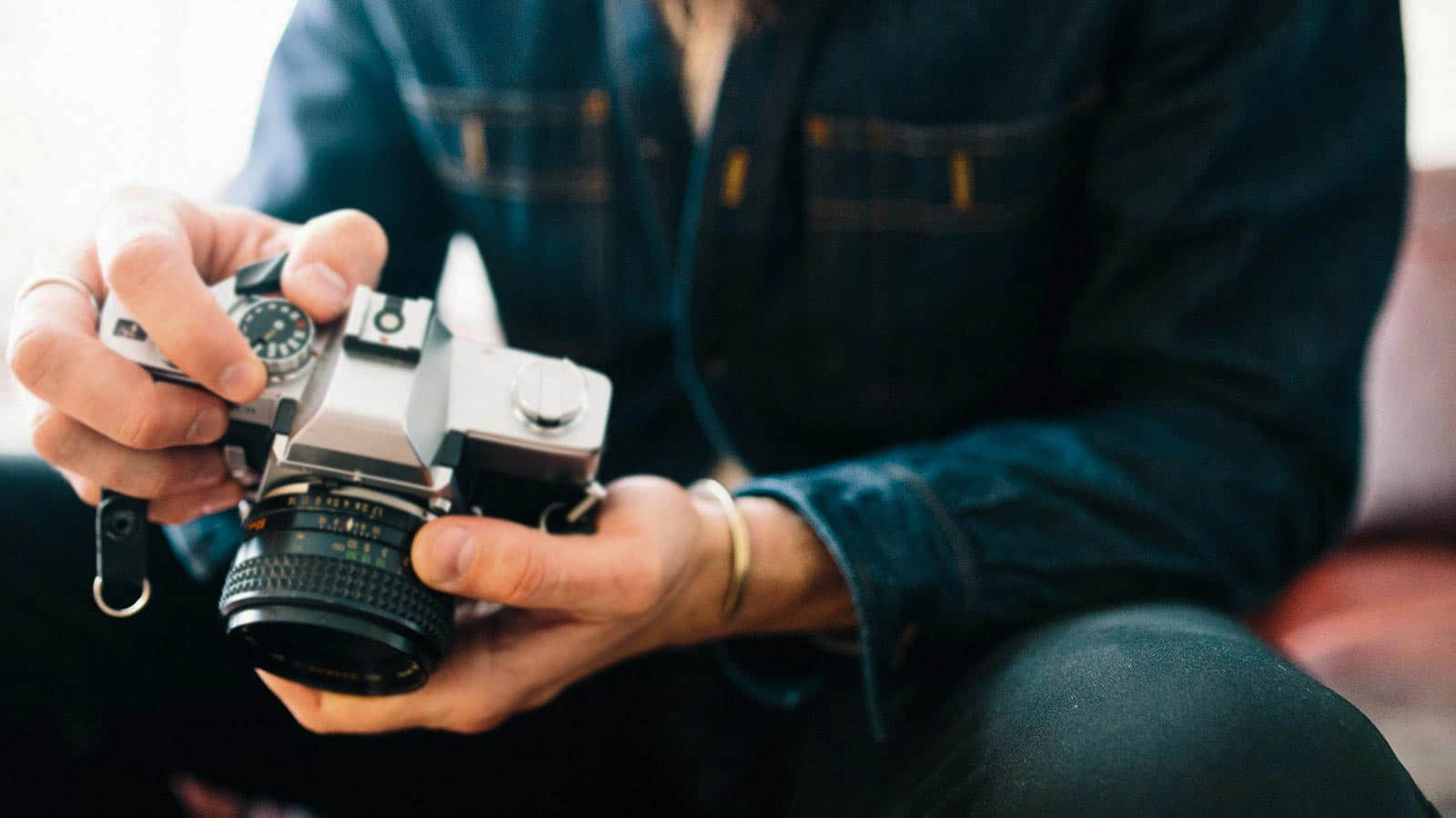 man holds film camera